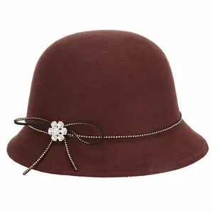 Elegant dark brown wool felt bucket hat with gold polka dot ribbon and rhinestone brooch
