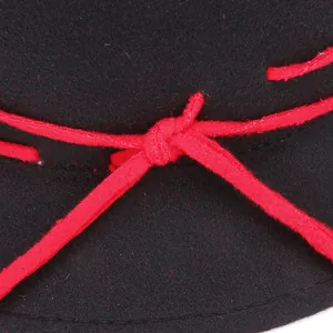 Close-up of black wool felt tophat featuring a decorative red knotted rope detail
