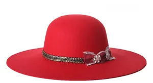 Detail of red wool felt fedora featuring black braided band and rhinestone flower trim
