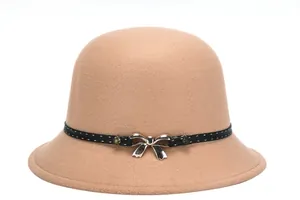 Detailed close-up of camel wool cloche hat with black ribbon and silver bow accessory