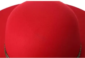 Close-up of vibrant red wool felt fedora showing the smooth texture and domed crown detail