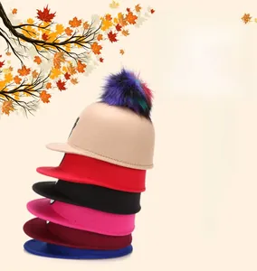 Stack of colorful felt cat ear hats with faux fur pom-poms in various stylish shades
