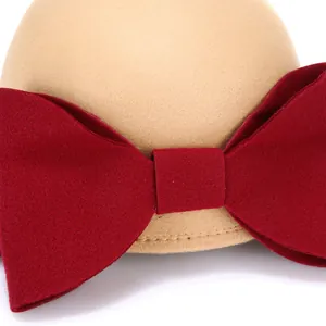 Women's camel wool equestrian hat featuring a large burgundy felt bow detail