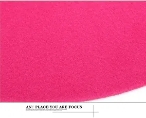 Detailed macro shot of deep pink wool felt material with smooth edges and fiber texture
