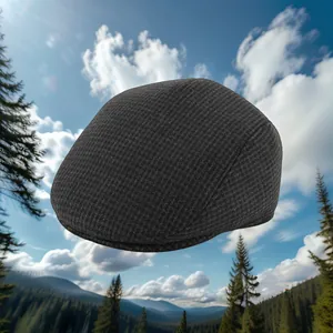 Close-up of a dark grey winter flat cap with ear protection and warm fleece lining