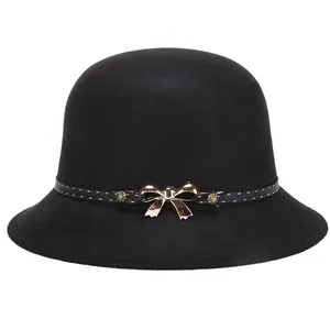 Elegant black wool cloche hat for women with polka dot band and rose gold bow accent
