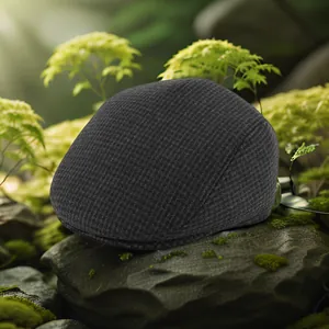 Detail of grey winter flat cap with waffle knit texture on a natural mossy rock