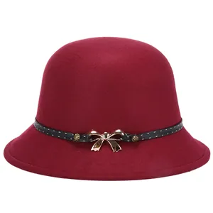 Elegant wine red wool cloche hat with a polka dot ribbon and golden bow accent