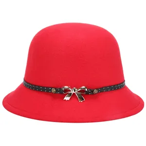 Elegant red wool felt bowler hat featuring a polka dot ribbon and silver bow ornament