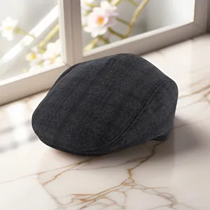 Detailed view of the dark grey textured tweed winter cap for elderly men on marble surface