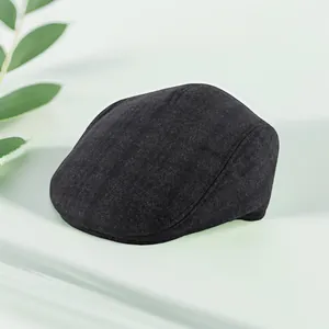 Close-up of charcoal grey winter flat cap with thick fleece texture and ear protection