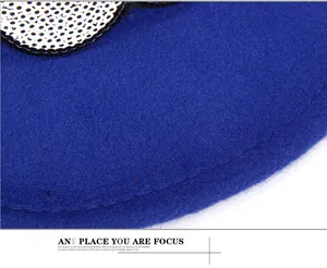 Close-up of royal blue felt hat fabric featuring silver sequin pattern and stitching