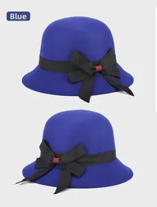Detail view of the blue wool felt bucket hat with a black bow and soft suede texture