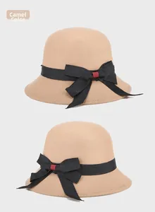Detailed views of a camel wool cloche hat featuring a large black bow with red accents