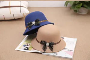 Close-up of wool cloche hats with lace bows and rhinestones on a fashion magazine