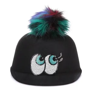 Fashionable black wool fedora hat with colorful pom-poms and sequin cartoon eyes