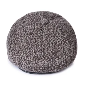 Top view of a gray wool flat cap showing thick tweed texture and fabric-covered button