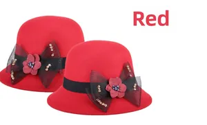 Détail du chapeau cloche en feutre de laine rouge avec nœud en maille et fleurs 3D