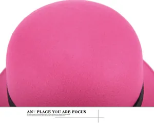 Detail of hot pink wool felt hat crown with elegant black decorative band and texture