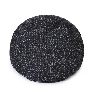 Detailed top view of heathered grey winter newsboy cap with a premium button and leather trim