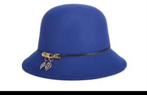 Close-up of royal blue wool cloche hat with black band and gold leaf pendants