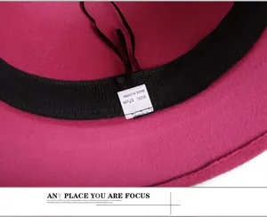 Detailed macro view of magenta wool fedora interior with sweatband and size label