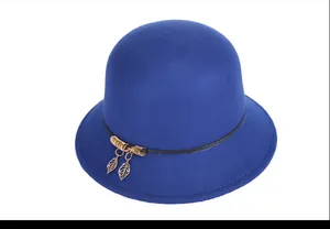 Detail of royal blue wool cloche hat with black band and golden leaf pendants
