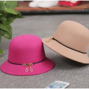 Chic women wool cloche hats in fuchsia and beige with gold leaf metal pendants