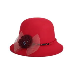 Elegant red wool felt bowler hat for women featuring a crochet flower and mesh bow detail