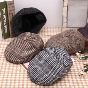 Detail of vintage wool blend flat caps in plaid and grey textures for winter warmth
