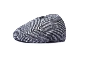 Detail shot of men's wool blend flat cap featuring grey houndstooth pattern and top button
