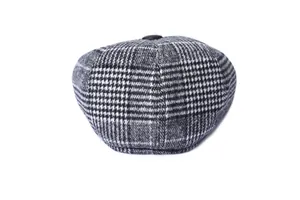 Detailed view of the woven houndstooth pattern and button on the winter ivy cap top