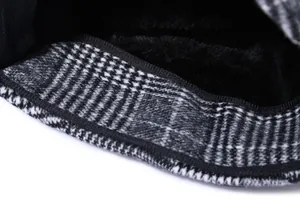 Detail of winter hat showing warm black plush lining and houndstooth wool fabric
