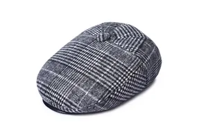 Detail view of a men's plaid wool flat cap showing texture and decorative top button