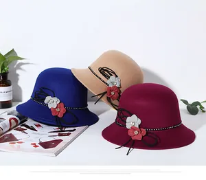 Three elegant felt bowler hats in blue, khaki, and burgundy with floral and crystal decor
