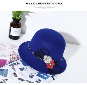 Detailed close-up of blue wool felt cloche hat with floral accents and crystal details