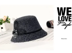 Detail view of dark grey tweed winter hat featuring a net mesh bow and soft fur pompom