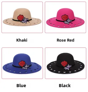 Detail of wool fedora hats with heart cutouts and floral embroidery in four colors