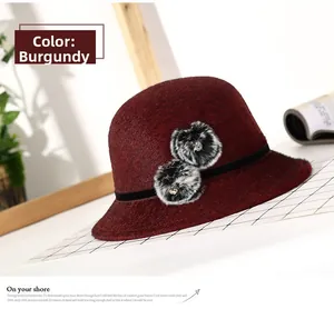 Elegant wine red winter bucket hat with faux fur pompom accents for women