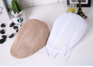 Detail of khaki and white mesh newsboy caps showing breathable knit texture and weave