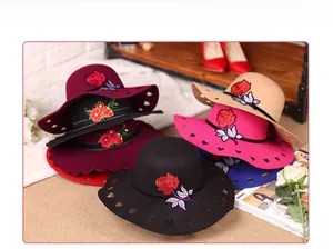 Detail showing wool felt hats with rose embroidery and heart cutout brim in multiple colors