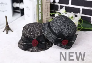 Detail of elegant wool cloche hats for women with floral ribbon and pearl accents