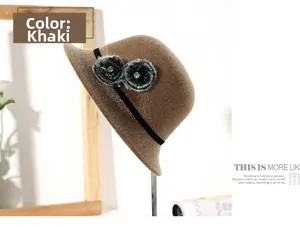 Detail of khaki plush bucket hat featuring faux fur flowers and rhinestone accents