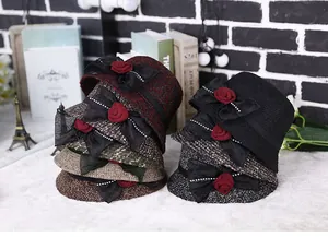 Detail of wool cloche hats with lace bows, fabric roses and sparkling rhinestones