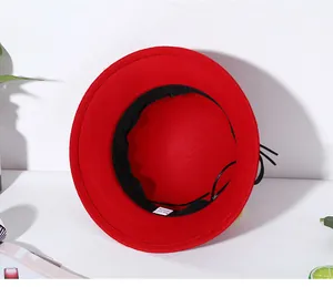 Detail view of red felt wool hat showing interior size label 57cm and sweatband
