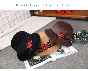 Three elegant felt hats for women with red floral embroidery in black, camel, and brown