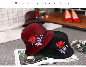 Detail of rose embroidery and sparkling rhinestones on elegant winter faux mink fur hats