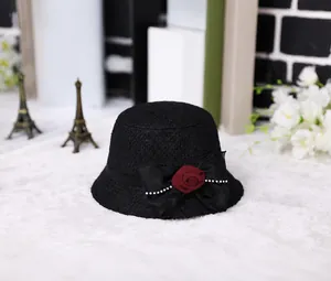 Detail of wool felt cloche hat with satin bow, red rose and rhinestone accents