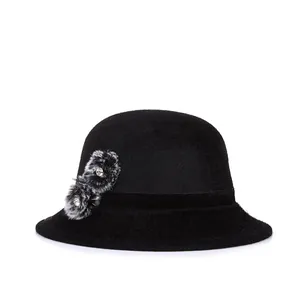 Elegant black faux fur basin hat for women featuring velvet band and rhinestone pom-poms