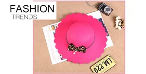 Detail of rose red wool fedora with wavy scalloped brim and leopard print bow decoration